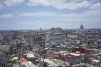 a large city with old buildings, some with red roofs and lots of other buildings
