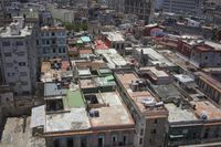 a large city with old buildings, some with red roofs and lots of other buildings