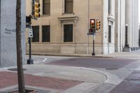 a corner with several stop lights at a city intersection and a red light at the intersection