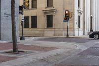 a corner with several stop lights at a city intersection and a red light at the intersection