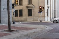 a corner with several stop lights at a city intersection and a red light at the intersection