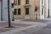 a corner with several stop lights at a city intersection and a red light at the intersection