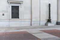 an image of a corner at a bank building with a fire hydrant on it's side