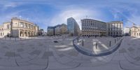 there is a city square that has circular buildings on one side and a large building with a curved roof