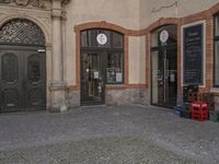 this is an image of a door and a clock on the building's facade