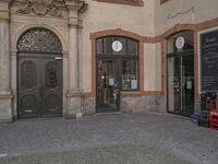 this is an image of a door and a clock on the building's facade