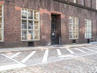 a bicycle is parked at the end of a road in front of a brick building