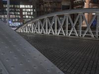 a footbridge is shown with metal plates for each platform to sit above it and next to a building