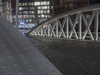 a footbridge is shown with metal plates for each platform to sit above it and next to a building