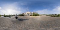 an aerial view of a driveway and a building from outside as if at home with a fisheye lens