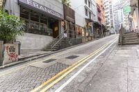 a street with two lane steps going up and a restaurant near by in the background