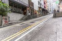 a street with two lane steps going up and a restaurant near by in the background