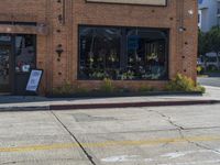 a fire hydrant sitting on the curb in front of a business next to a street