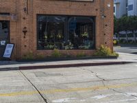 a fire hydrant sitting on the curb in front of a business next to a street