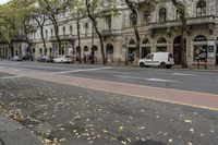 this is a street that is full of cars, bicycles and pedestrians on it and people walking by
