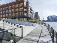 this is a large building with multiple windows and doors, along with an outside bench, two bicycles, and a ramp