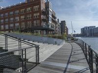 this is a large building with multiple windows and doors, along with an outside bench, two bicycles, and a ramp