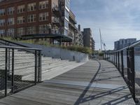 this is a large building with multiple windows and doors, along with an outside bench, two bicycles, and a ramp