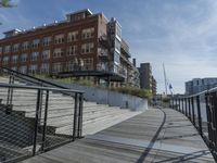 this is a large building with multiple windows and doors, along with an outside bench, two bicycles, and a ramp