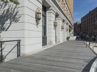 this is a large building with multiple windows and doors, along with an outside bench, two bicycles, and a ramp