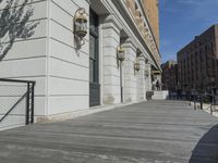 this is a large building with multiple windows and doors, along with an outside bench, two bicycles, and a ramp