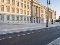 a road near a building with windows and lights on it is shown here in the distance, in europe