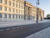 a road near a building with windows and lights on it is shown here in the distance, in europe