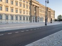 a road near a building with windows and lights on it is shown here in the distance, in europe