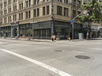 the street is crowded with many shops and businesses on this side walk area near a red traffic light