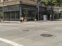 the street is crowded with many shops and businesses on this side walk area near a red traffic light