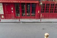 there is a large red door to a restaurant that looks like it has been cleaned