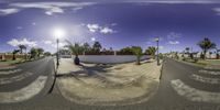 the road from one side is empty of cars as it comes to the right in this 360 - 360 photograph