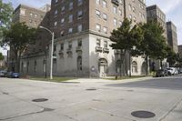 a parking meter is on the sidewalk near buildings in the city that has cement floors
