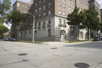 a parking meter is on the sidewalk near buildings in the city that has cement floors