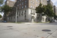 a parking meter is on the sidewalk near buildings in the city that has cement floors