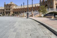 a very large building and some steps leading up to the side of a road in front of it