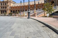 a very large building and some steps leading up to the side of a road in front of it