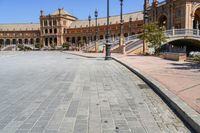 a very large building and some steps leading up to the side of a road in front of it