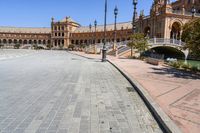 a very large building and some steps leading up to the side of a road in front of it