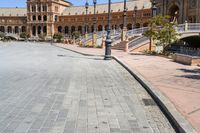 a very large building and some steps leading up to the side of a road in front of it