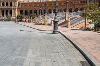 a very large building and some steps leading up to the side of a road in front of it