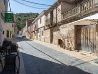 a motorcycle parked next to some old buildings on a cobblestone street in a town