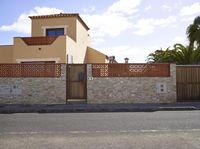 this is an outdoor image of a building and fenced off street area from the outside