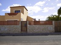 this is an outdoor image of a building and fenced off street area from the outside