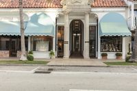 store front with a row of windows with several large awnings on top of it