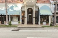 store front with a row of windows with several large awnings on top of it