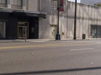 the front of a large building next to a street with a bike on the street