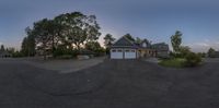 a circular image shows an old house with parking lot on the sidewalk and driveway at sunset