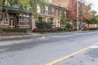 a street that has a car parked on it and a brick building with many windows