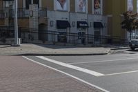 a car stopped at an intersection on a city street, on a clear day with no people